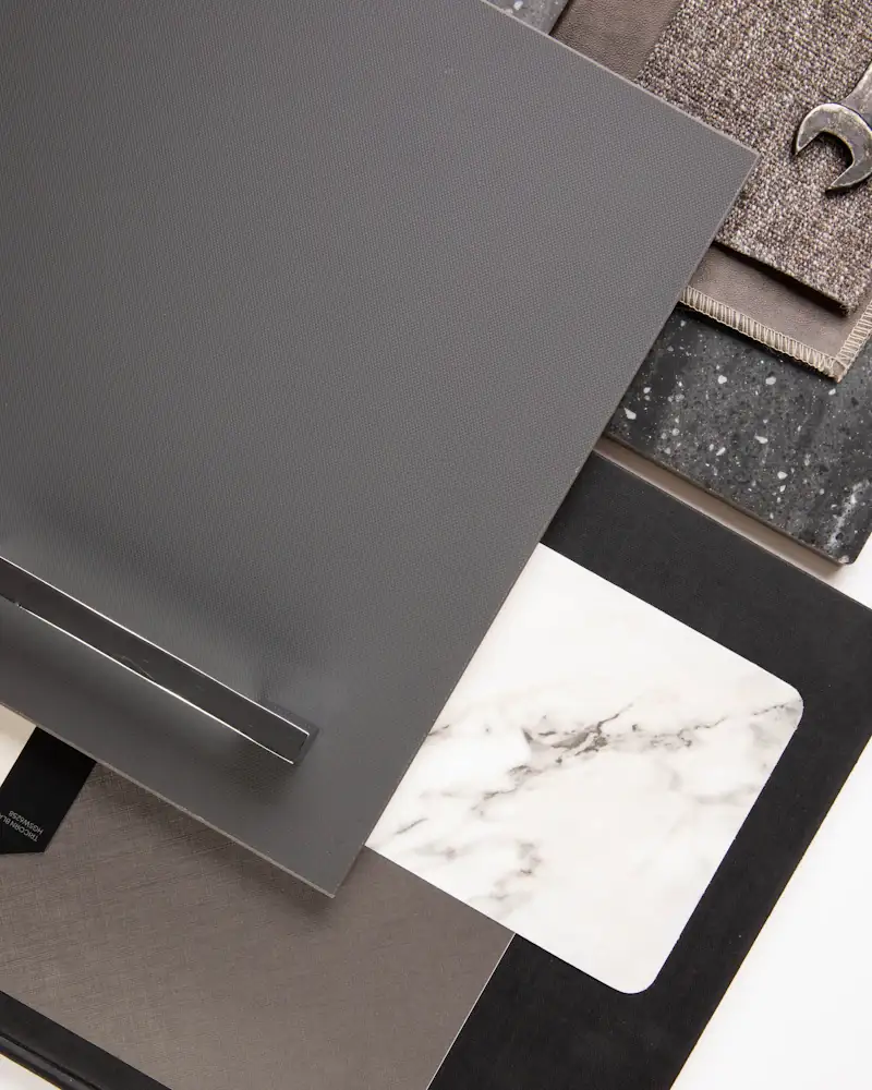 Assorted material samples: stone, terrazzo and dark laminates