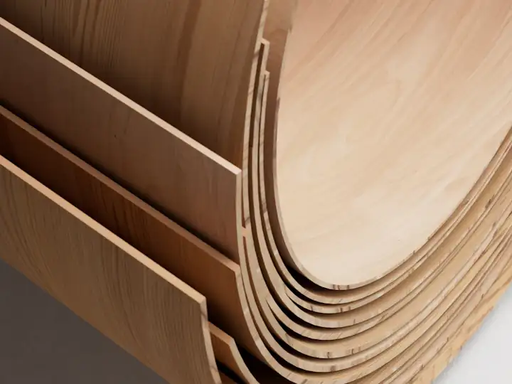 Thin sheets of natural wood veneer curling at the edges
