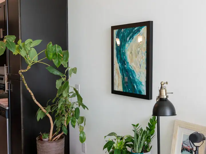 Framed painting above a sofa in a styled living room